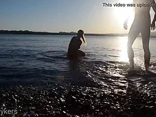 Passionate couple shares intimate moments on a public shore