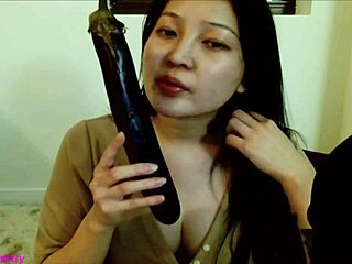 Asian girl gets her mouth filled with eggplant in ASMR video